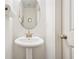 Elegant powder room featuring a pedestal sink and modern fixtures, ideal for guests at 6415 Shalks Crossing Dr, Lithonia, GA 30058