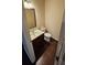 Compact half-bathroom with wood floors, a dark vanity, and a traditional mirror and light fixture at 3084 Turman Cir, Decatur, GA 30033