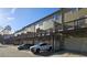 Townhomes with balconies, garage parking, and additional street parking against a backdrop of a clear blue sky at 3084 Turman Cir, Decatur, GA 30033