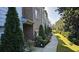 Charming brick townhome featuring a sidewalk surrounded by manicured landscaping and lush greenery at 3084 Turman Cir, Decatur, GA 30033