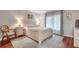 Comfortable bedroom with wood floors, a spacious window, and neutral decor at 3085 Colonial Way # L, Atlanta, GA 30341