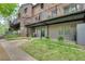Exterior view of the back of the townhomes, featuring a porch and green space at 3085 Colonial Way # L, Atlanta, GA 30341