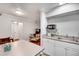 Compact kitchenette providing essential appliances and an open view into the cozy living area at 3085 Colonial Way # L, Atlanta, GA 30341