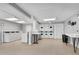 Well-lit laundry room featuring multiple washers, dryers, folding tables and large windows at 3085 Colonial Way # L, Atlanta, GA 30341