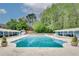 Large community swimming pool with cabanas and lush greenery in the background at 3085 Colonial Way # L, Atlanta, GA 30341