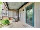 View of the covered back porch with brick and siding details and an open view to the backyard at 3085 Colonial Way # L, Atlanta, GA 30341