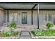 View of the front porch with potted plants, a rocking chair, and the front door at 3085 Colonial Way # L, Atlanta, GA 30341