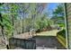 Backyard featuring a playground and wooded area with grass and mulch at 320 Hillside Manor Dr, Sugar Hill, GA 30518