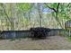 Fenced backyard area with mature landscaping at 320 Hillside Manor Dr, Sugar Hill, GA 30518