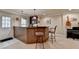 Basement bar area featuring wood paneled bar, pendant lights, tile floor, and barstool seating at 320 Hillside Manor Dr, Sugar Hill, GA 30518