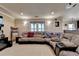 Finished basement with plush carpeting, recessed lights, large sectional sofa, and bar area at 320 Hillside Manor Dr, Sugar Hill, GA 30518