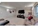 Finished basement with plush carpeting, recessed lights, and large sectional sofa at 320 Hillside Manor Dr, Sugar Hill, GA 30518