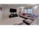 Finished basement with plush carpeting, recessed lights, and large sectional sofa at 320 Hillside Manor Dr, Sugar Hill, GA 30518