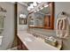 Bathroom featuring wood cabinets, an elongated vanity, a decorative mirror, and neutral paint at 320 Hillside Manor Dr, Sugar Hill, GA 30518