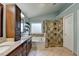Bathroom featuring dual sinks, separate tub, tiled shower, and natural light at 320 Hillside Manor Dr, Sugar Hill, GA 30518