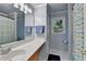 Bright bathroom featuring double sinks, a shower, and a blue accent color scheme at 320 Hillside Manor Dr, Sugar Hill, GA 30518