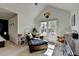 Bright bedroom with vaulted ceilings, chair, and natural light streaming through the large windows at 320 Hillside Manor Dr, Sugar Hill, GA 30518