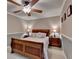 Comfortable bedroom featuring crown molding, a ceiling fan, and bedside tables at 320 Hillside Manor Dr, Sugar Hill, GA 30518