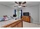 Welcoming bedroom features a ceiling fan, a workspace, and warm natural light at 320 Hillside Manor Dr, Sugar Hill, GA 30518