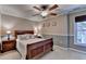 Well-lit bedroom featuring crown molding, ceiling fan, and window with natural light at 320 Hillside Manor Dr, Sugar Hill, GA 30518