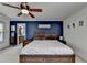 Primary bedroom featuring a large bed, ceiling fan, and ensuite bathroom entrance at 320 Hillside Manor Dr, Sugar Hill, GA 30518