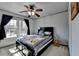 Cozy bedroom with a ceiling fan, natural light, and comfortable furnishings at 320 Hillside Manor Dr, Sugar Hill, GA 30518