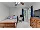Comfortable bedroom with a workspace, dresser, and natural light at 320 Hillside Manor Dr, Sugar Hill, GA 30518