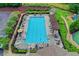 Overhead view of a large community pool, surrounded by lounge chairs, landscaping, and shade structures at 320 Hillside Manor Dr, Sugar Hill, GA 30518