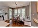 Bright breakfast nook featuring built-in bench seating, ample natural light, and scenic outdoor views at 320 Hillside Manor Dr, Sugar Hill, GA 30518