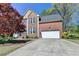 Charming two-story brick home with two-car garage and manicured lawn at 320 Hillside Manor Dr, Sugar Hill, GA 30518