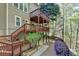 Exterior of the home featuring a multi-tiered deck and lush landscaping at 320 Hillside Manor Dr, Sugar Hill, GA 30518