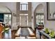 Bright foyer featuring hardwood floors, a staircase, and an arched entryway to other rooms at 320 Hillside Manor Dr, Sugar Hill, GA 30518