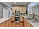 Modern kitchen with stainless steel appliances, hardwood floors, and ample counter space for food preparation at 320 Hillside Manor Dr, Sugar Hill, GA 30518