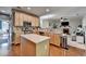 Well-appointed kitchen featuring an island, stainless steel appliances and tile backsplash at 320 Hillside Manor Dr, Sugar Hill, GA 30518