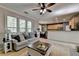 Inviting living room with large windows, comfortable seating, and a decorative rustic wooden coffee table at 320 Hillside Manor Dr, Sugar Hill, GA 30518
