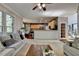 Bright living room showcases neutral tones, plush seating, and seamless flow into the adjacent kitchen at 320 Hillside Manor Dr, Sugar Hill, GA 30518