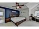 Spacious main bedroom featuring a ceiling fan, with a dark accent wall at 320 Hillside Manor Dr, Sugar Hill, GA 30518