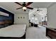 Spacious main bedroom featuring a ceiling fan, sitting area, and ample space at 320 Hillside Manor Dr, Sugar Hill, GA 30518