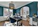The beautiful office area has a large window, a pendant light, blue paint, and a desk at 320 Hillside Manor Dr, Sugar Hill, GA 30518
