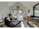 Bright sitting room with vaulted ceilings, sofa, and ample natural light at 320 Hillside Manor Dr, Sugar Hill, GA 30518