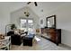 Bright sitting room with vaulted ceilings, sofa, and ample natural light at 320 Hillside Manor Dr, Sugar Hill, GA 30518