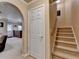 Staircase leading to a finished basement with an arched entryway and neutral walls at 320 Hillside Manor Dr, Sugar Hill, GA 30518