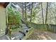 Stone walkway with wooden stairs and retaining walls leading to the backyard at 320 Hillside Manor Dr, Sugar Hill, GA 30518