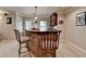 Finished basement wet bar featuring a counter, barstool seating, and cabinets for storage and entertaining at 320 Hillside Manor Dr, Sugar Hill, GA 30518