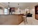 Finished basement wet bar featuring a counter, barstool seating, and cabinets for storage and entertaining at 320 Hillside Manor Dr, Sugar Hill, GA 30518