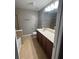 Primary bathroom featuring double sink vanity, tile flooring, and neutral paint at 4036 Carlinswood Way, Stone Mountain, GA 30083