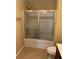 A clean bathroom features a shower and tub combo with sliding glass doors, and a toilet at 4036 Carlinswood Way, Stone Mountain, GA 30083