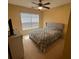 Bedroom features a plush bed, ample natural light from the window, a ceiling fan, and a cozy ambiance at 4036 Carlinswood Way, Stone Mountain, GA 30083