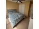Cozy bedroom with a large bed, a ceiling fan, and neutral colors, perfect for relaxation at 4036 Carlinswood Way, Stone Mountain, GA 30083