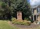 Dominion Station community sign surrounded by lush landscaping and mature trees at 4036 Carlinswood Way, Stone Mountain, GA 30083